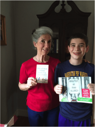 Carol and grandson Asher Kranowitz with his book, Absolutely No Dogs Allowed (Sensory World, 2015)