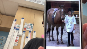 Adria Michelman standing beside a horse