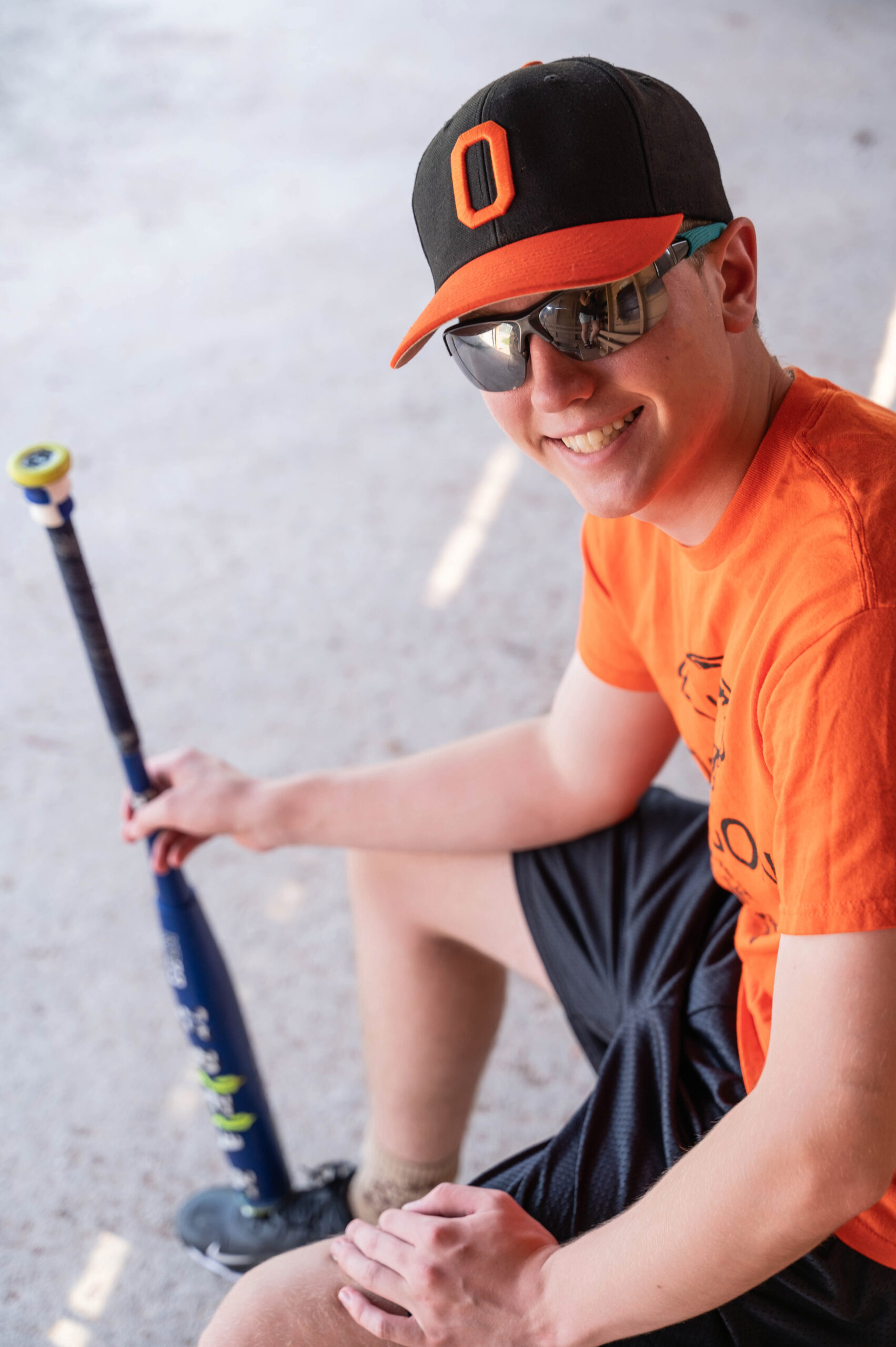 Clyde Fruits smiling while holding a softball bat