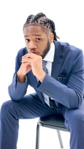 Isaiah Stringfield seated in a blue suit