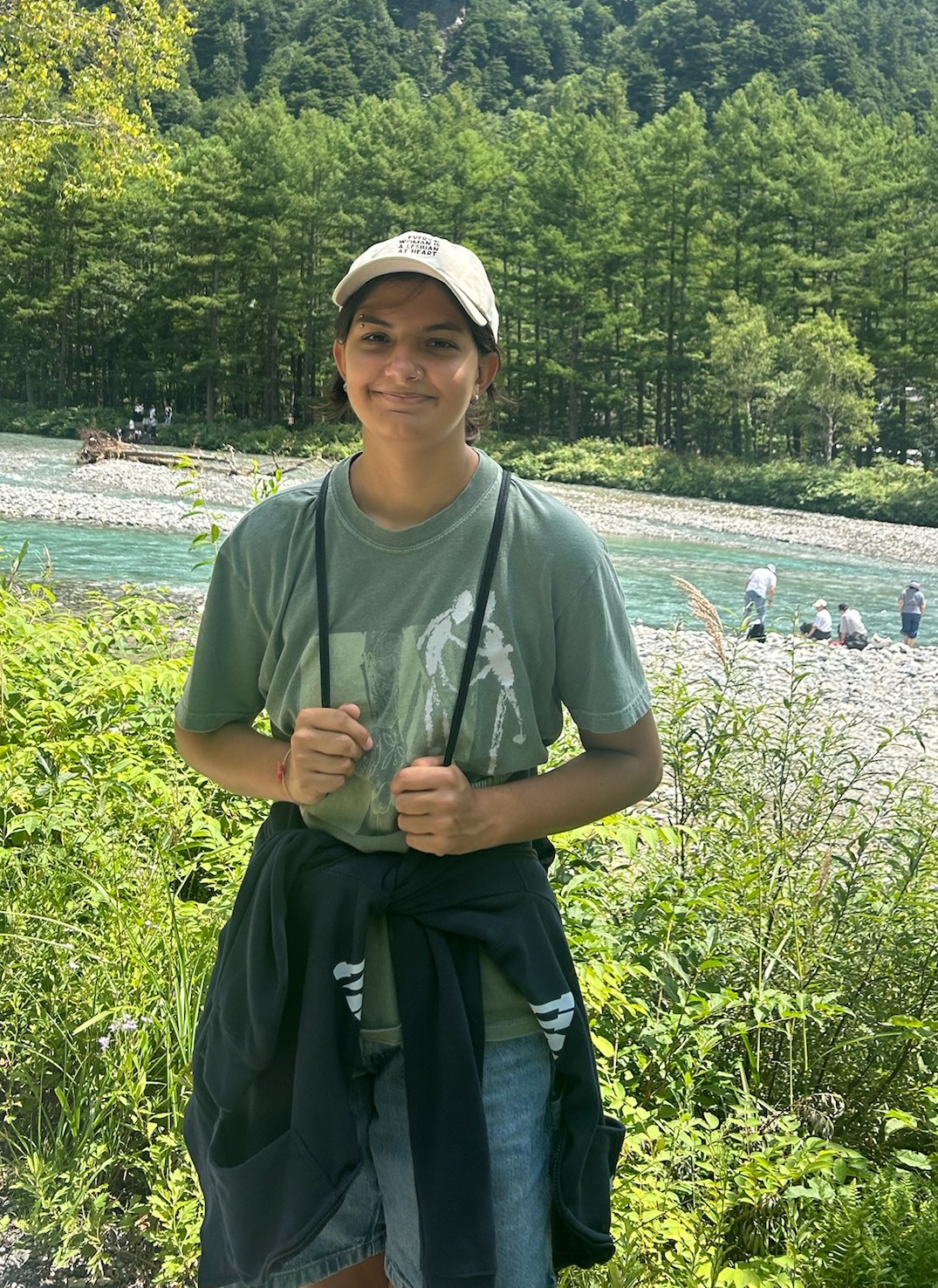 Laila LaPierre hiking beside a river