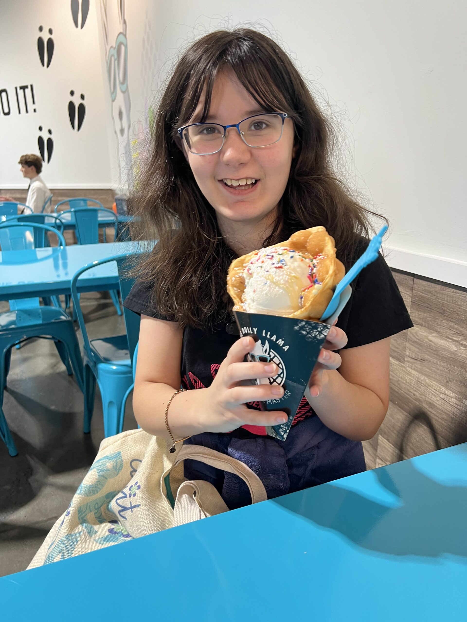 Reagan Dempsey smiling while holding an ice cream dessert