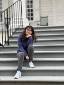 Reagan Dempsey seated on outdoor steps