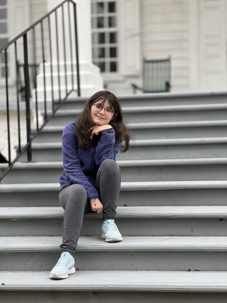 Reagan Dempsey seated on outdoor steps