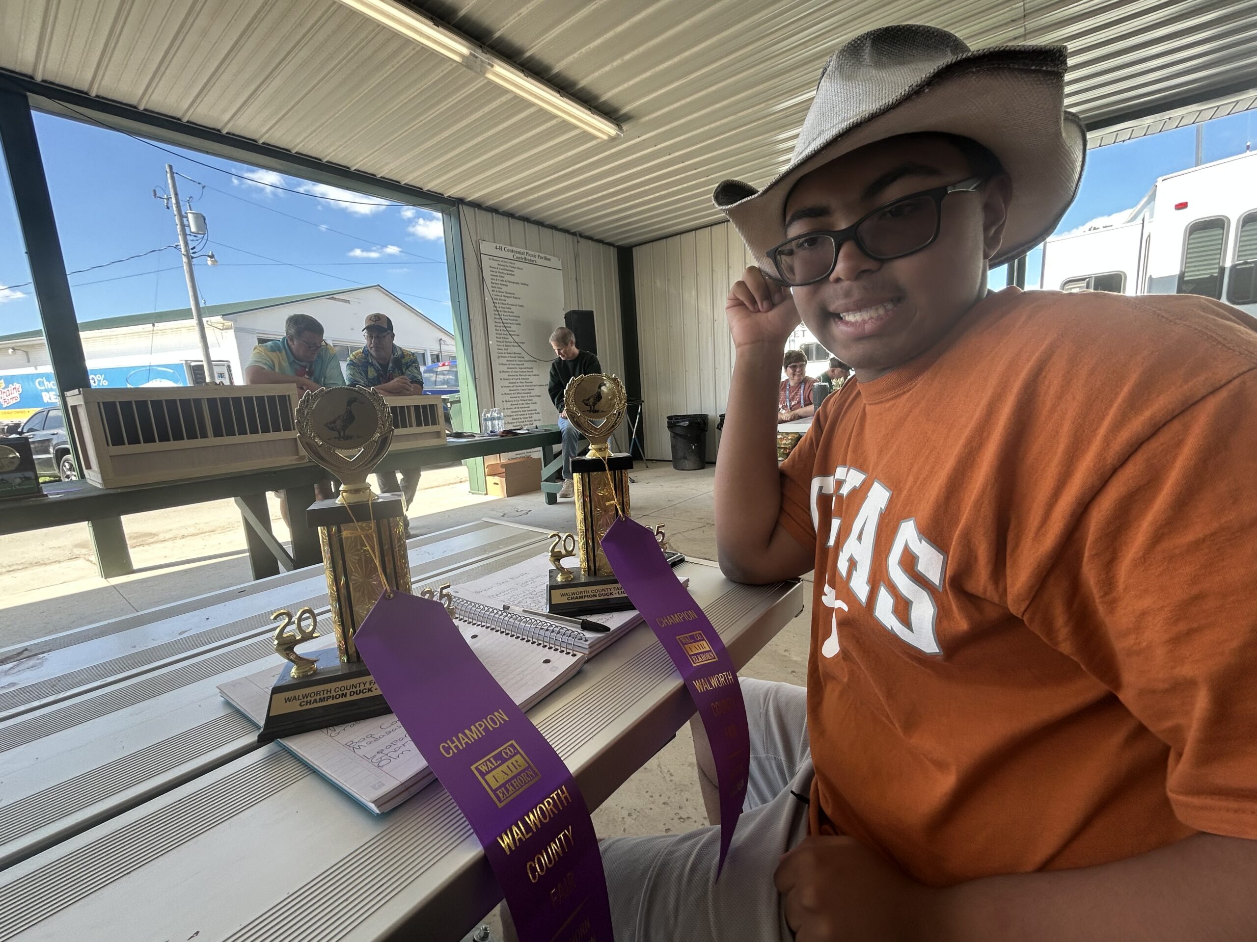 Tai Lin with awards from showing animals at the county fair