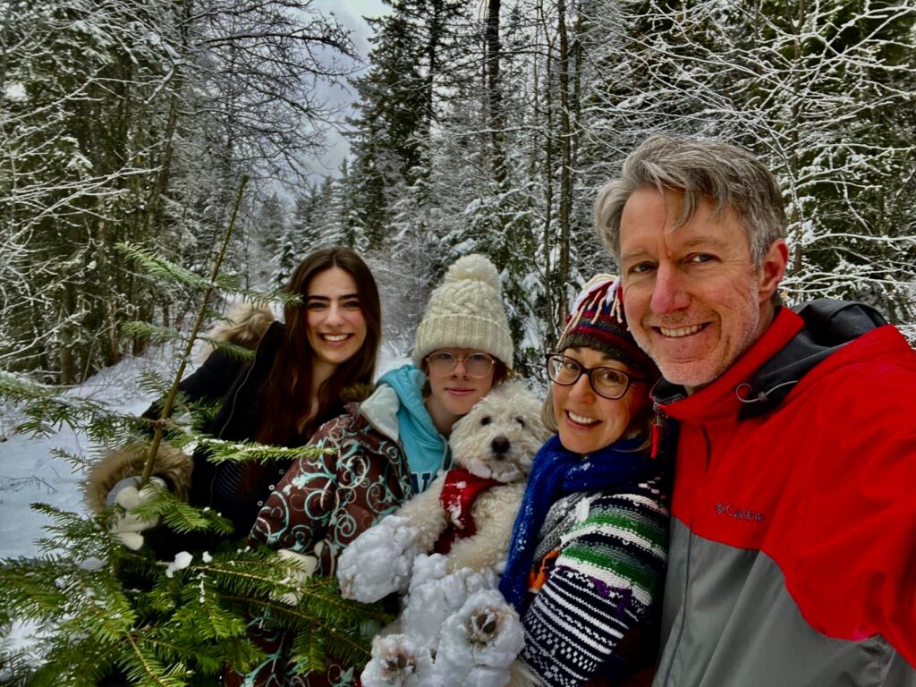 Kyah Lawe with her family outdoors in a snowy forest