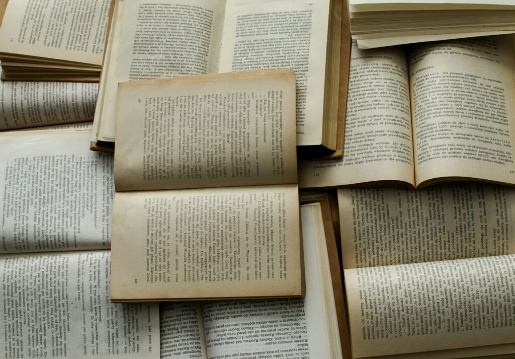 Open books in warm light, a stock photograph representing curiosity and learning.