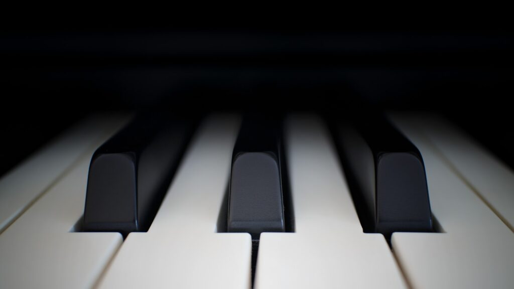 A close-up of black and white piano keys, a stock photograph representing practice and persistence.