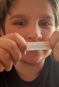 Ryan Johnson holding a fortune-cookie message.