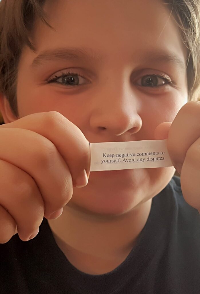 Ryan Johnson holding a fortune-cookie message.